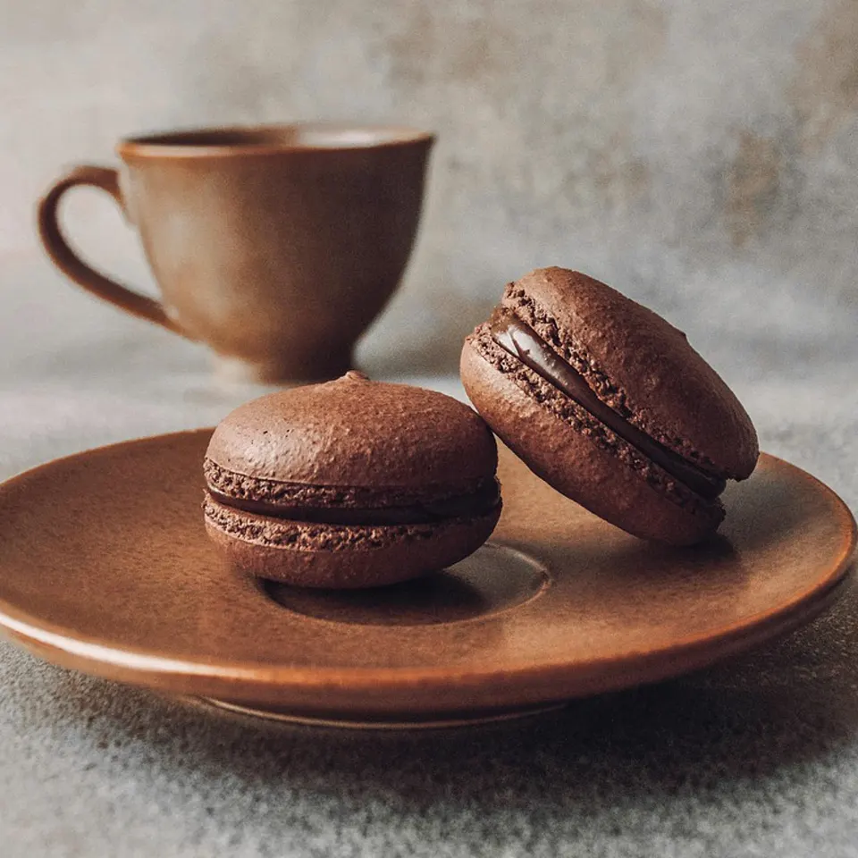 Tea in a clay cup with chocolate mignardises
