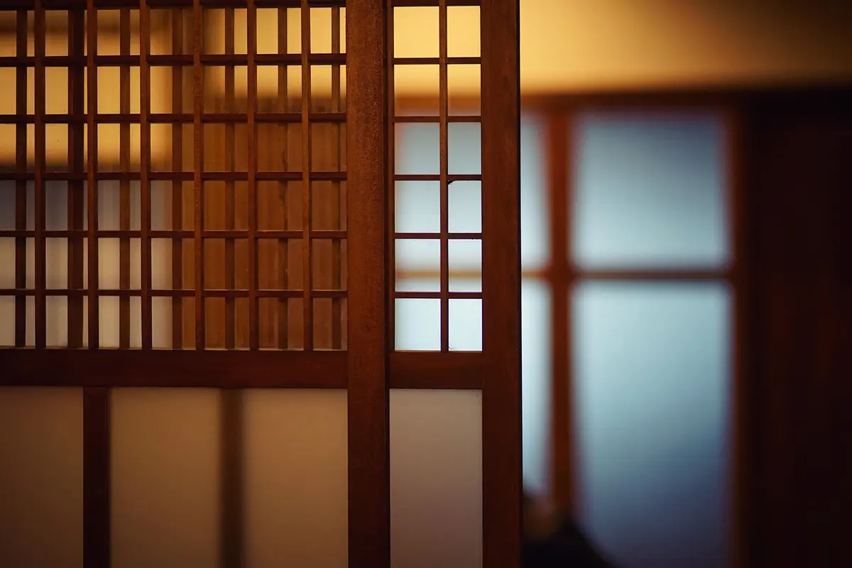 Timber shoji screens glowing with borrowed street light
